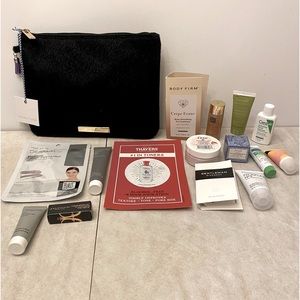 Black faux fur makeup bag with purple tassel and samples